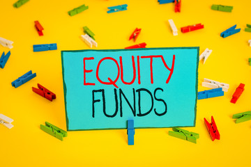 Text sign showing Equity Funds. Business photo showcasing type of mutual fund that buys ownership in businesses Colored clothespin papers empty reminder yellow floor background office