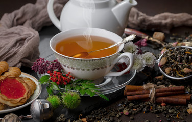 Tea hot drink on old background in composition on the table