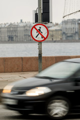 A person's road sign is forbidden. The road with the car and the sign on the street pass man is forbidden. 