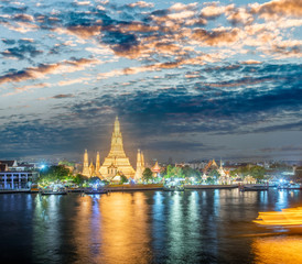 Night view of Wat Arun Ratchawararam temple. Beautiful sunset at Chao Phraya river, landmark thailand tourist spot, Bangkok - Thailand