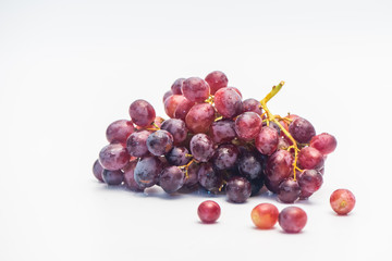 A bunch of red grapes isolated on a white background.