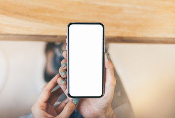 Mockup image blank white screen cell phone.man hand holding texting using mobile on desk at coffee shop.background empty space for advertise text.people contact marketing business,technology 