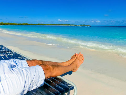picture of male legs over tropical beach background