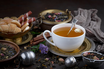 Tea hot drink on old background in composition on the table