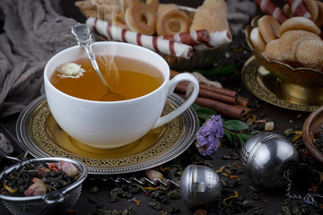 Tea hot drink on old background in composition on the table