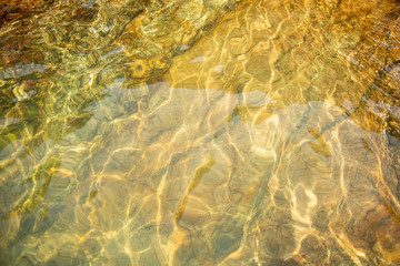 Obraz premium In the summer, the sun shines and the background of water waves flickers. The texture of the water. 