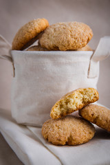 homemade biscuits in a linen basket on a beige background. cracked cookies. Healthy sweets cooking for family.