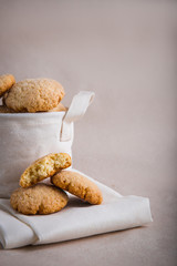 homemade biscuits in a linen basket on a beige background. cracked cookies. Healthy sweets cooking for family.