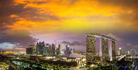 Fototapeta na wymiar Singapore at sunset. Aerial view of Marina Bay and Downtown from drone