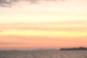 The seaside at sunset has dark shadows in the form of mountains.take photos blur
