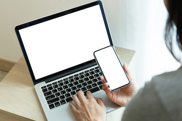 mockup image blank screen computer,cell phone with white background for advertising text,hand woman using laptop texting mobile contact business search information on desk in cafe.marketing,design