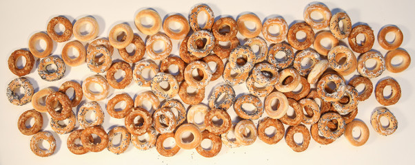 Bublik cookies pattern. Pile of ring shaped roll cookies with different glaze..