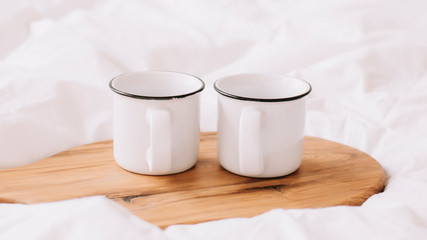 Fototapeta na wymiar White cups. Breakfast in bed. White bedroom. Sweet home. coffee cup. flat lay