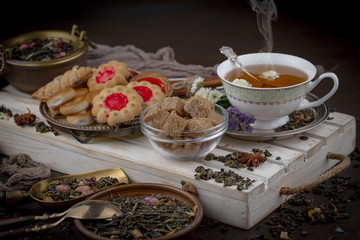 Tea hot drink on old background in composition on the table