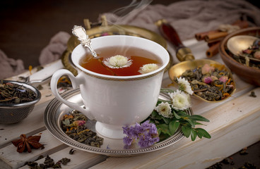 Tea hot drink on old background in composition on the table