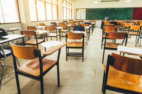 Selective Soft And Blur Focus.old Wooden Row Lecture Chairs In Dirty Classroom In Poor School.study Room Without Student.concept For Education In Third World ,donate And Charity,background Text.