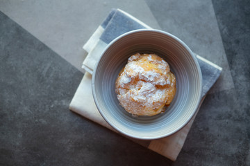 Cream puffs filled vanilla custard and dusted with icing