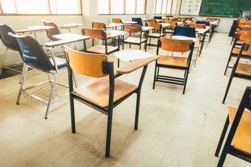 selective soft and blur focus.old wooden row lecture chairs in dirty classroom in poor school.study...