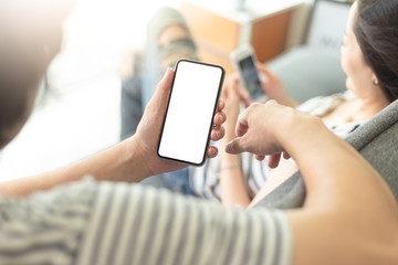 Mockup image blank white screen cell phone.man hand holding texting using mobile sitting at coffee shop.background empty space for advertise text.people contact marketing business,technology 