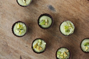 Delicious chocolate candies with pistachios on the table