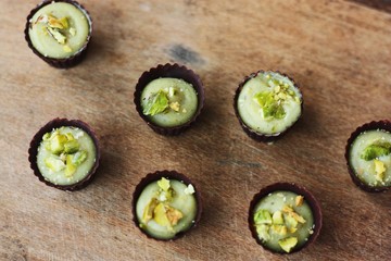 Delicious chocolate candies with pistachios on the table