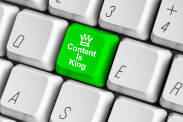 Green content is king key on the white computer keyboard.