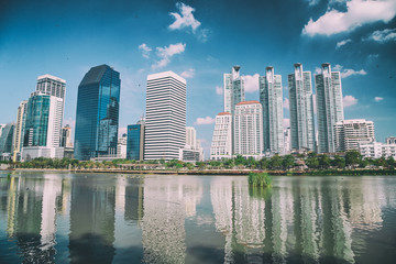 Fototapeta na wymiar Lake and city buildings from Benjakitti Park in Bangkok