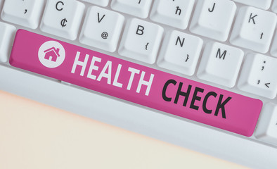 Writing note showing Health Check. Business concept for thorough physical examination A medical checkup of oneself White pc keyboard with note paper above the white background