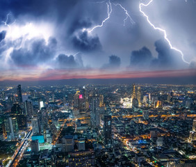 Naklejka na ściany i meble Aerial sunset view of Bangkok modern skyline during a storm, Thailand