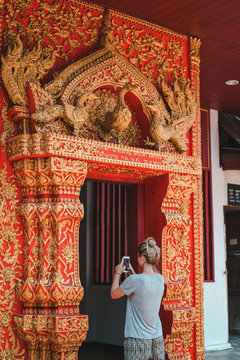 Turista rubia sacando foto a templo