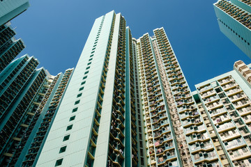 Fototapeta na wymiar looking up on high-rise apartment building, residential building facade, hongkong