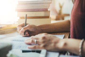high school,university student study.hands holding pencil writing paper answer sheet.sitting lecture chair taking final exam attending in examination classroom.concept scholarship for education abroad