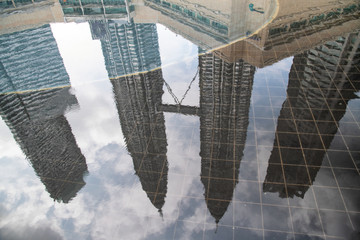 Kuala Lumpur skyline reflection in a puddle, Malaysia