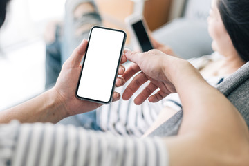 Mockup image blank white screen cell phone.man hand holding texting using mobile sitting at coffee shop.background empty space for advertise text.people contact marketing business,technology 