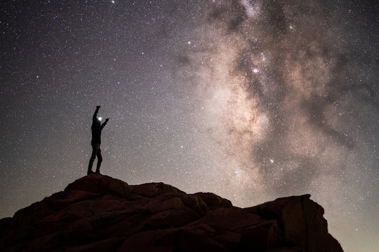 Silhouette of a hiker standing on mountain with is arms in the air, Sequoia National Park, California, USA