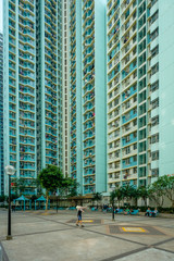 People on court of high-rise apartment building, residential building complex in Hong Kong