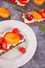 Crisp bread with creme cheese, fruit and berries