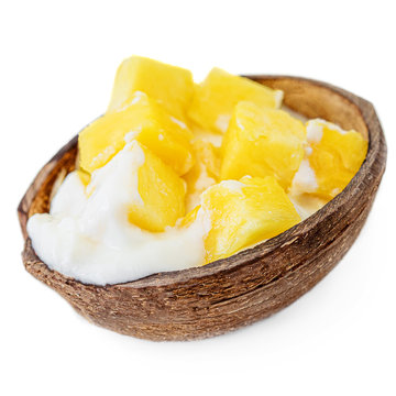 Exotic Dessert - Coconut Yogurt and sweet mango pieces. Frozen Ice-Cream isolated on white background.