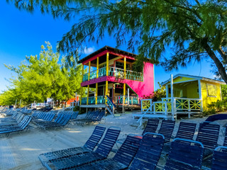 Colorful tropical cabanas or shelters on the beach of Half Moon Cay