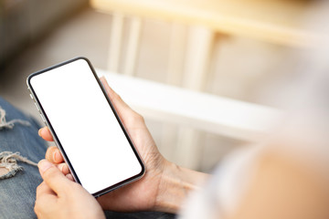 Mockup image blank white screen cell phone.man hand holding texting using mobile sitting at coffee shop.background empty space for advertise text.people contact marketing business,technology 