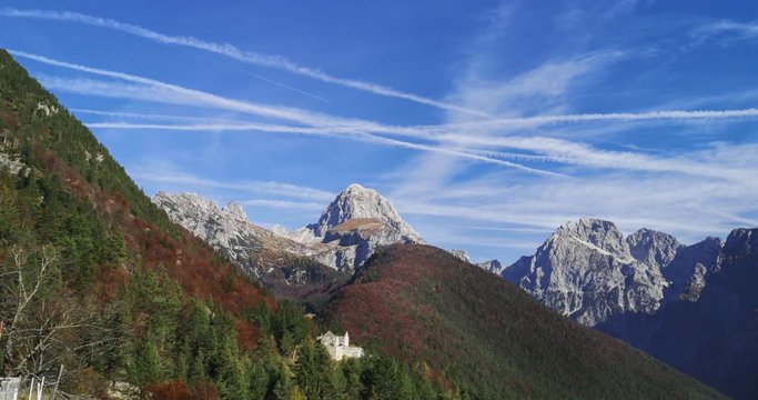 Time lapse Julian Alps with mountain Mangart and Predil fotress ruins in foreground