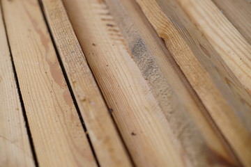 Fototapeta premium Set of wooden planks, pile of sawn bars closeup.
