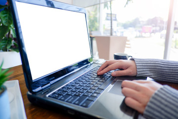 Cropped shot view of business woman’s hands typing the labtop with blank copy space screen for your information content or text message.