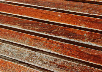 A close up color image of weathered boards taken on a slant.