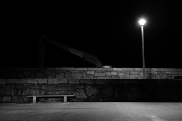 Moody Nightscape Featuring a Digger and a Bench