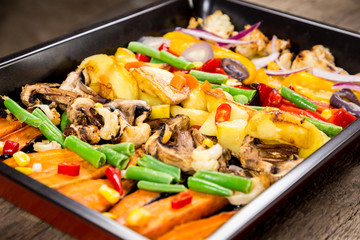 Chopped stewed vegetables on tray, food background, closeup