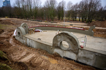 Concrete wall construction on the street. Work and improvement of the park in the city. Creating a...
