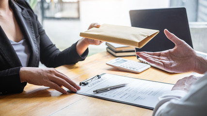 Dishonest cheating in illegal money, Business woman giving bribe money the form of dollar bills to...