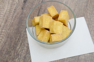 bowl of fried tofu isolated on wooden