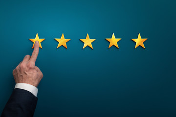 Hand of businessman touching one star symbol, low rating